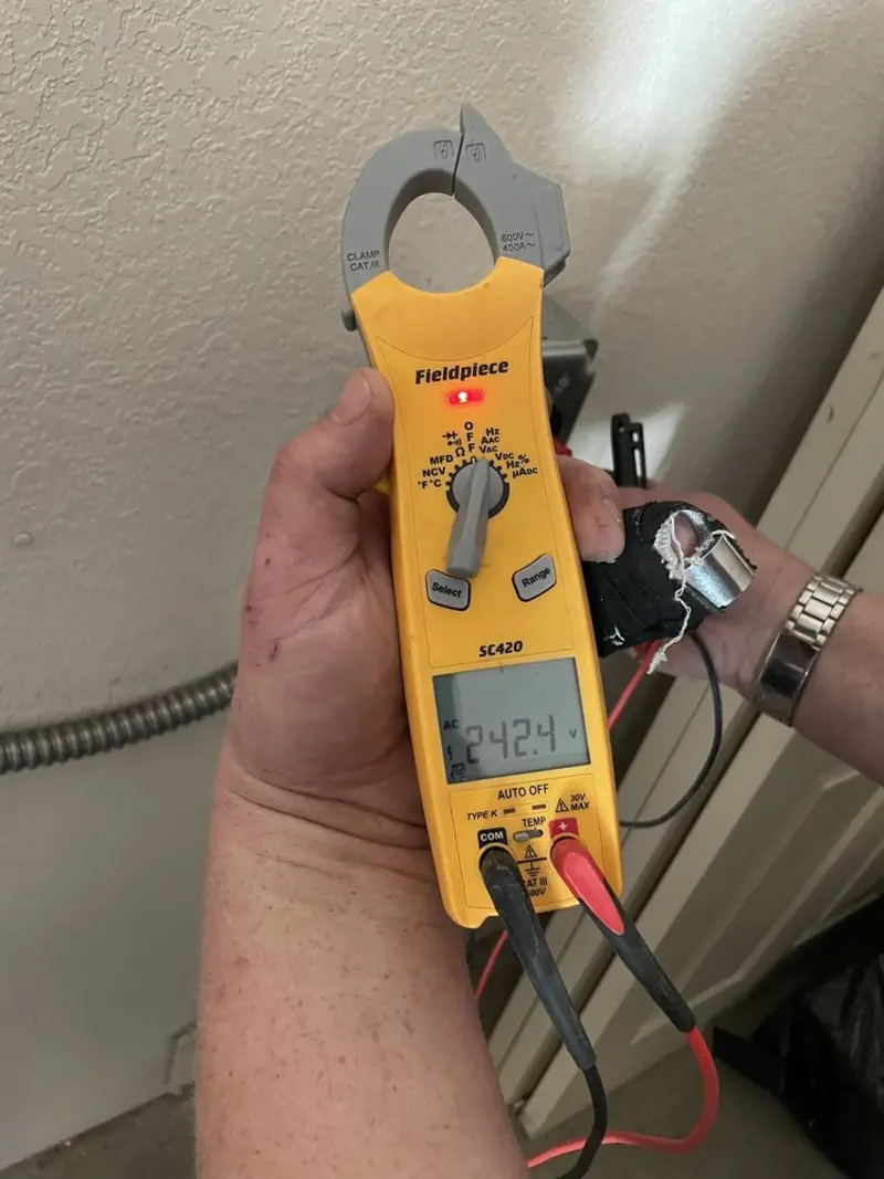 Voltage testing with clamp meter during Ceiling Fan Installation in Winona